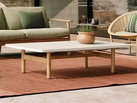 Kettal Riva teak outdoor furniture in a garden, catalog photograph